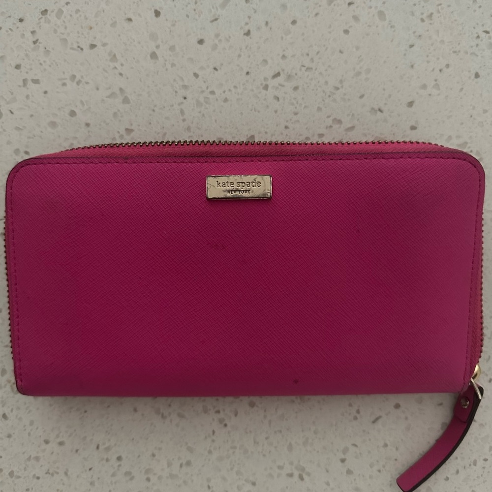 Kate Spade leather wallet in good condition. Pink gently warn.